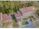 Aerial view of townhomes featuring brick exteriors, well-maintained lawns and a driveway leading to a two-car garage at 3571 Edington Way, Palm Harbor, FL 34685