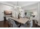 Bright dining room with a modern chandelier and views into the living room and entry way at 3609 W Iowa Ave, Tampa, FL 33611