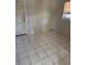 A bedroom features white tile floors, a window and a door at 4501 27Th S Ave, Gulfport, FL 33711