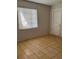 A bedroom shows tile floors and a window for natural light at 4501 27Th S Ave, Gulfport, FL 33711