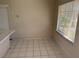 View of dining room area showing white tile floors and a large window for natural light at 4501 27Th S Ave, Gulfport, FL 33711
