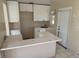 View of kitchen, featuring white cabinets, tile floor, and laminate countertops at 4501 27Th S Ave, Gulfport, FL 33711