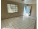 The living room has white tile floors, a window and a door at 4501 27Th S Ave, Gulfport, FL 33711