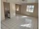 Living room featuring white tile floors, and two windows providing natural light at 4501 27Th S Ave, Gulfport, FL 33711