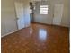 An empty room shows wood like floors, and a door and window at 4501 27Th S Ave, Gulfport, FL 33711