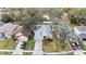 Aerial view of gray home with a long driveway, mature trees, and well-maintained landscaping at 4717 Dunnie Dr, Tampa, FL 33614