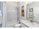 Clean bathroom with a shower and tub combination, white cabinets, and vanity at 4717 Dunnie Dr, Tampa, FL 33614