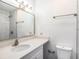 Modern bathroom featuring a vanity with quartz countertop, large mirror, and neutral fixtures at 4928 W Gandy Blvd # G203, Tampa, FL 33611
