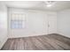 Bright bedroom featuring gray wood floors, white walls, and ample natural light at 4928 W Gandy Blvd # G203, Tampa, FL 33611