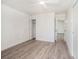 Bedroom with wood-look floors, ceiling fan, and an open door leading to another room at 4928 W Gandy Blvd # G203, Tampa, FL 33611
