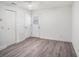 Bedroom with wood-look floors, ceiling fan, and white doors leading outside at 4928 W Gandy Blvd # G203, Tampa, FL 33611