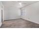 Bright bedroom with gray wood floors, white walls, a ceiling fan and ample sunlight at 4928 W Gandy Blvd # G203, Tampa, FL 33611