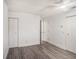Bedroom with gray wood floors, white walls, a ceiling fan, and ample closet space at 4928 W Gandy Blvd # G203, Tampa, FL 33611