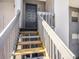 Staircase leading to unit entrance with painted door and modern hardware at 4928 W Gandy Blvd # G203, Tampa, FL 33611