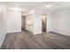 Bright living room with gray wood floors, white walls, and a modern ceiling fan at 4928 W Gandy Blvd # G203, Tampa, FL 33611