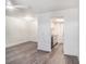 Open floor plan with wood-look floors, ceiling fan, and open view to the kitchen at 4928 W Gandy Blvd # G203, Tampa, FL 33611
