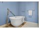 Freestanding white bathtub with modern fixtures and hardware on a neutral tile floor at 5010 Bayshore Blvd # 9, Tampa, FL 33611