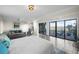 Bedroom with a bed, seating area, and windows showcasing water views at 5010 Bayshore Blvd # 9, Tampa, FL 33611