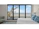 Bedroom with a bed, seating area, and large window offering water views at 5010 Bayshore Blvd # 9, Tampa, FL 33611