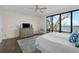 Bright bedroom featuring large windows with water views, light wood flooring, and stylish neutral decor at 5010 Bayshore Blvd # 9, Tampa, FL 33611