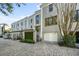 Exterior view of luxury townhome featuring beautiful landscaping and brick driveway at 5010 Bayshore Blvd # 9, Tampa, FL 33611
