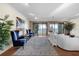 Bright living room showcasing hardwood floors, balcony access, and stylish blue and white accents at 5010 Bayshore Blvd # 9, Tampa, FL 33611
