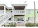 Multi-story home with exterior stairs, covered balconies, and patio at 5231 Beach Se Dr # A, St Petersburg, FL 33705