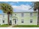 Exterior view of a two-story condo building with white trim and a well-kept lawn at 5231 Beach Se Dr # A, St Petersburg, FL 33705