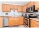 A kitchen features stainless steel appliances, wood cabinets, and a functional layout at 5231 Beach Se Dr # A, St Petersburg, FL 33705