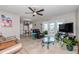 A cozy living room features tile floors, a ceiling fan, and access to the outdoor patio at 5231 Beach Se Dr # A, St Petersburg, FL 33705