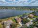 Aerial view of waterfront homes with pools and well-maintained lawns, set against a serene lake at 5325 Sandy Shell Dr, Apollo Beach, FL 33572