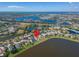 Stunning aerial view of a lakeside neighborhood with manicured lawns, mature trees, and beautiful water features at 5325 Sandy Shell Dr, Apollo Beach, FL 33572