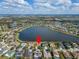 Stunning aerial view of home overlooking a picturesque lake in a vibrant community at 5325 Sandy Shell Dr, Apollo Beach, FL 33572