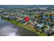 Aerial view of a charming neighborhood with lakefront properties, mature trees, and well-manicured lawns at 5325 Sandy Shell Dr, Apollo Beach, FL 33572