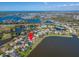 Picturesque aerial view of a lakeside community featuring lovely homes, lush greenery, and serene water views at 5325 Sandy Shell Dr, Apollo Beach, FL 33572