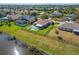 Lakeside house featuring a fenced backyard with pool, spa, and screened patio at 5325 Sandy Shell Dr, Apollo Beach, FL 33572