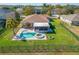 Backyard oasis featuring a pool, spa, screened patio, and lush landscaping at 5325 Sandy Shell Dr, Apollo Beach, FL 33572