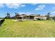Expansive backyard features a fire pit, screened lanai, and lush green lawn at 5325 Sandy Shell Dr, Apollo Beach, FL 33572