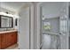 Bright bathroom leading to bedroom with light fixture and granite countertop sink at 5325 Sandy Shell Dr, Apollo Beach, FL 33572
