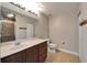 Bright bathroom with tile floors, a shower with glass doors, and a vanity with lots of storage space at 5325 Sandy Shell Dr, Apollo Beach, FL 33572