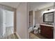 Bathroom with neutral paint, wood-look flooring, and wood vanity at 5325 Sandy Shell Dr, Apollo Beach, FL 33572