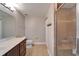 Bathroom featuring a double vanity, toilet, and glass-enclosed shower with tile surround at 5325 Sandy Shell Dr, Apollo Beach, FL 33572