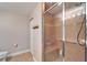Well-lit bathroom featuring a glass enclosed shower with a built-in bench and grab bar at 5325 Sandy Shell Dr, Apollo Beach, FL 33572