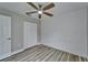 Bedroom featuring a ceiling fan, closet and a modern shiplap accent wall at 5325 Sandy Shell Dr, Apollo Beach, FL 33572