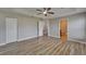 Expansive bedroom with tray ceilings, wood-style floors, closet, and an ensuite bathroom at 5325 Sandy Shell Dr, Apollo Beach, FL 33572