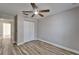 Bedroom with wood flooring, ceiling fan, and a spacious closet at 5325 Sandy Shell Dr, Apollo Beach, FL 33572