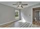 Well-lit bedroom with wood-look floors and neutral walls, creating a serene and inviting space at 5325 Sandy Shell Dr, Apollo Beach, FL 33572