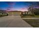 Inviting home with a three-car garage and a well-manicured lawn at dusk at 5325 Sandy Shell Dr, Apollo Beach, FL 33572