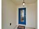 A beautiful blue front door with glass panels and a welcome mat, creating an inviting entryway at 5325 Sandy Shell Dr, Apollo Beach, FL 33572