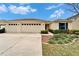 Inviting single-Gathering home with an attached two car garage, beautiful landscaping, and manicured lawn at 5325 Sandy Shell Dr, Apollo Beach, FL 33572